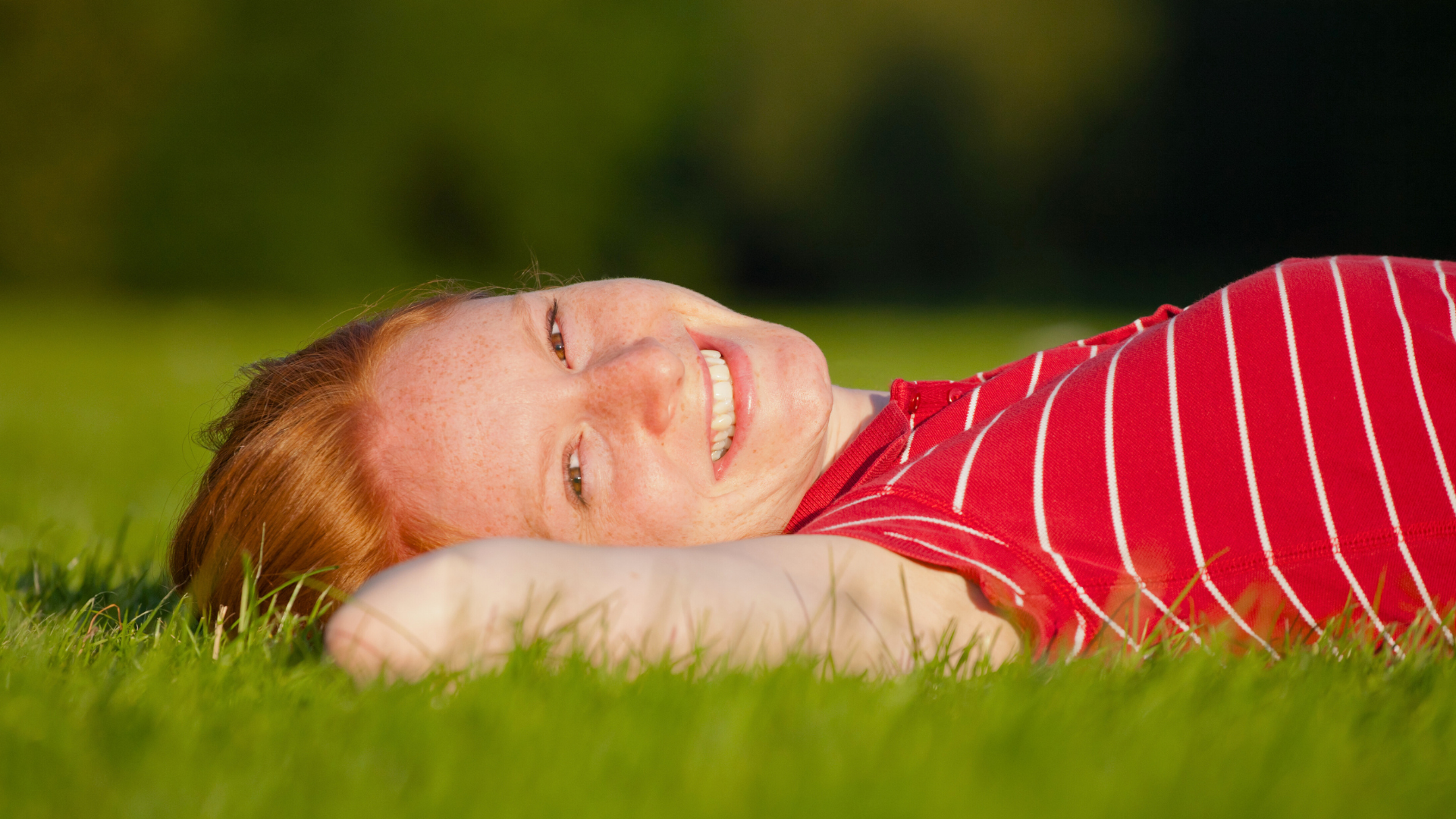 child lying on the grassfield