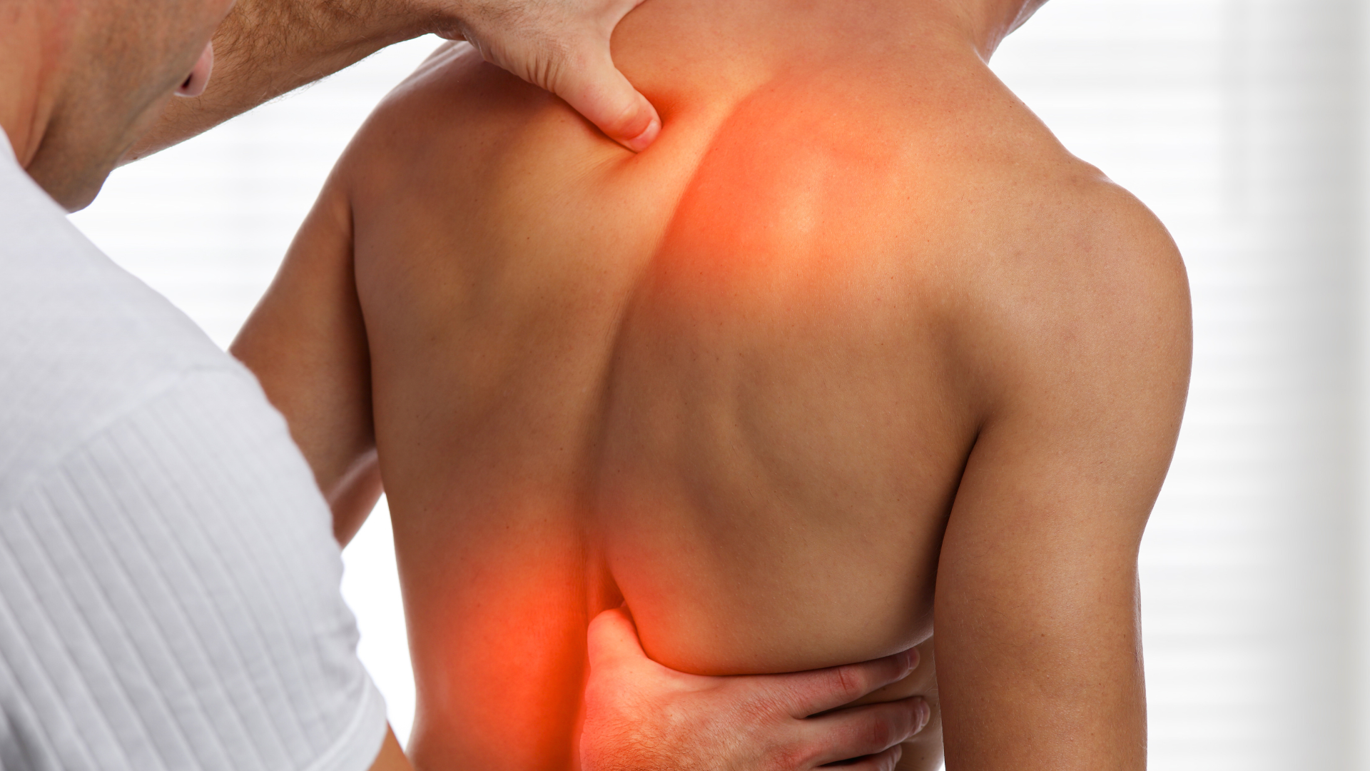 doctor checking man's inflamed back