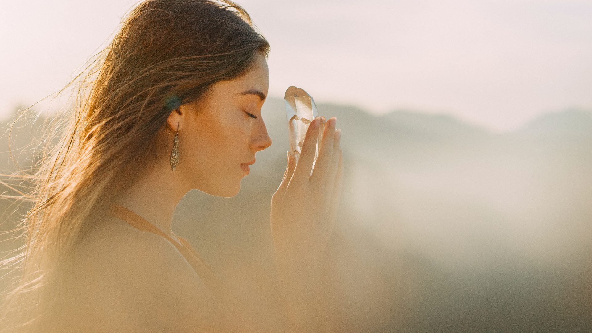 woman holding a white crystal