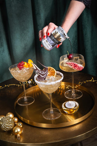 Pouring a SWISH martini into decorated glasses