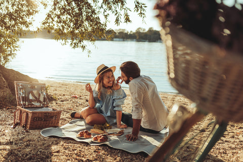young couple having a picnic on the beach