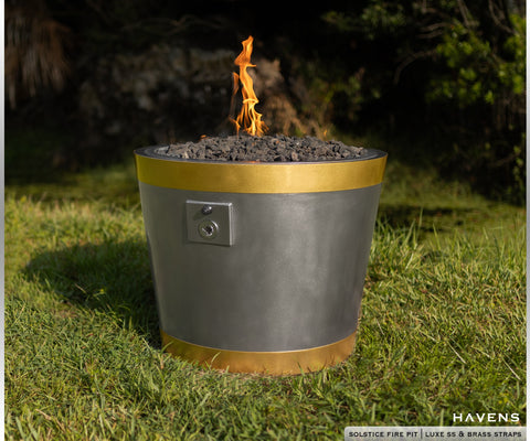Gas burning stainless steel fire pit with brass straps