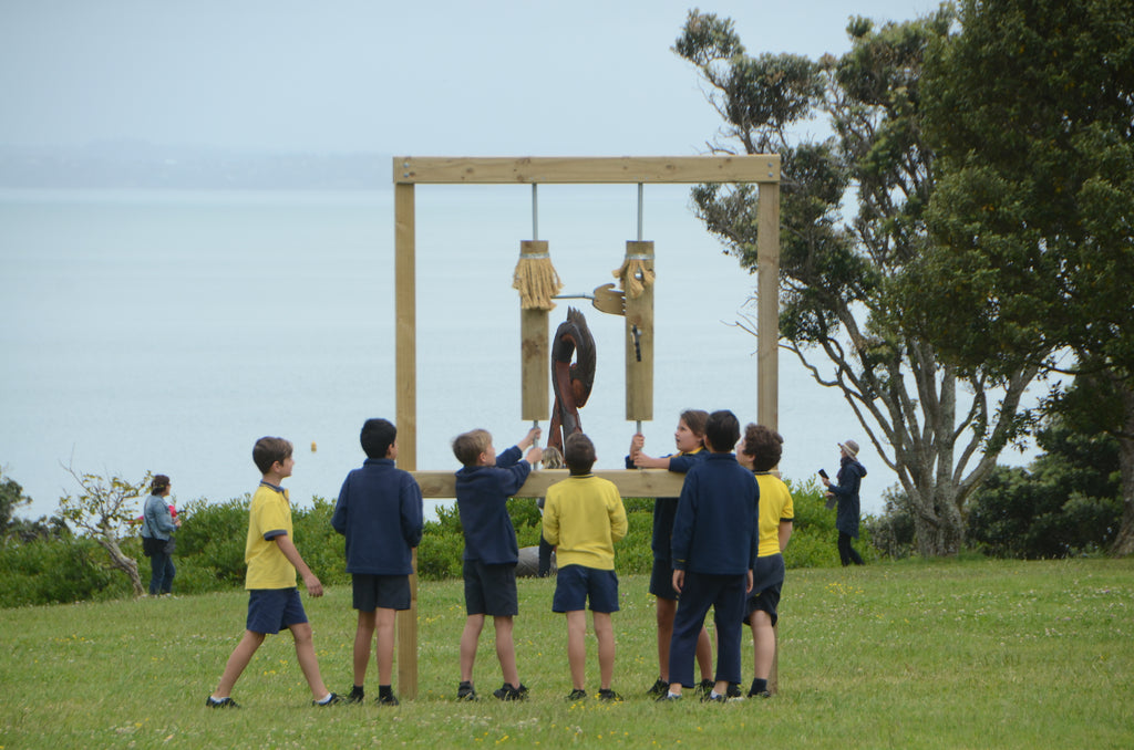 Kids interacting with an artwork at NZ Sculpture OnShore at Fort Takapuna, O Peretu