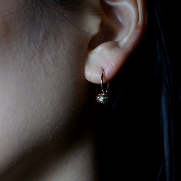 in her Herkimer Seed earrings-