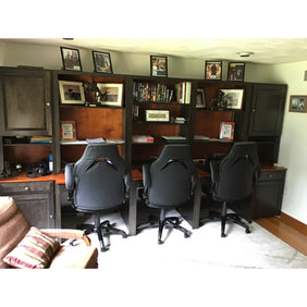 Custom multi desk unit with adjustable shelving and cabinets on either side.