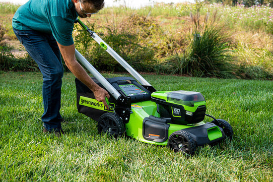 Man using a Greenworks battery-powered lawn mower