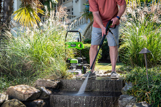 Man cleaning steps with Greenworks pressure washer