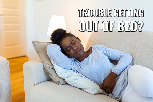 melanated woman laying on the couch cramping in pain due to her menstrual period and above her to the right it says "trouble getting out of bed?