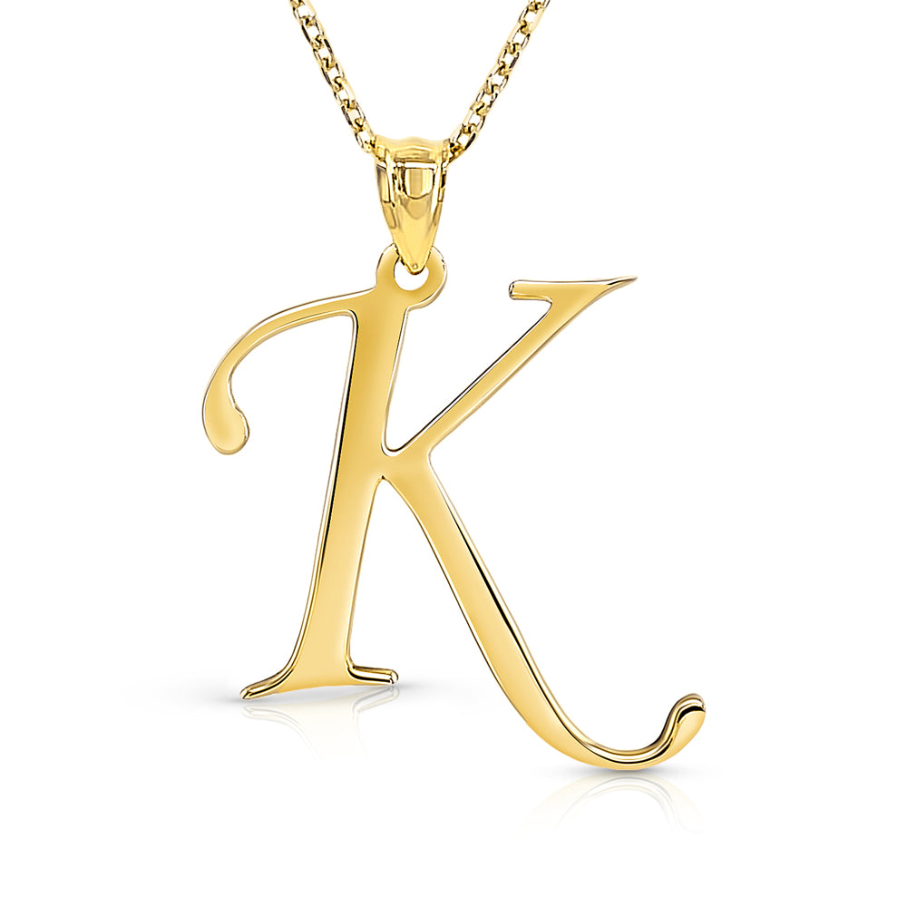 Gold letter K pendant on a gold chain against on a white bacground