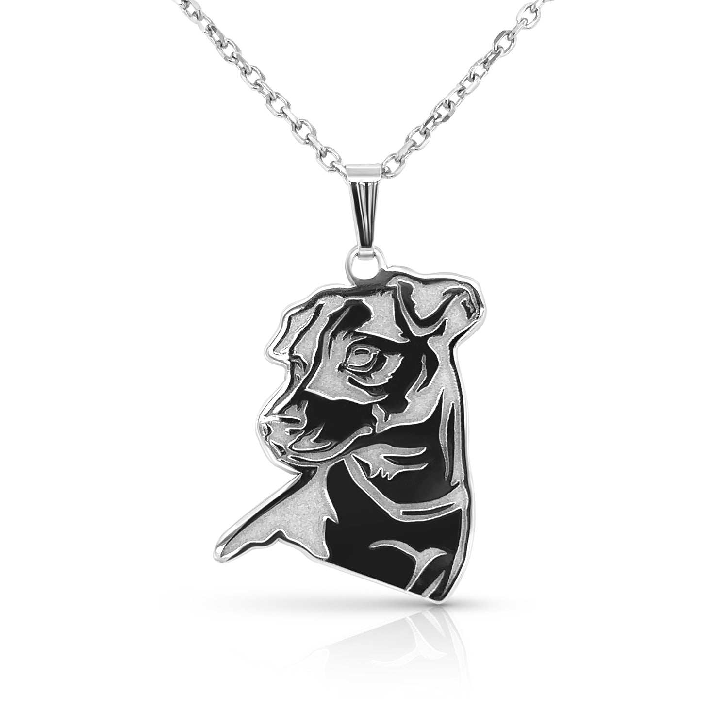 Silver pendant shaped out of a dog's face on a white background