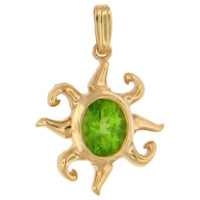 Gold sun pendant with central green gemstone on a white background