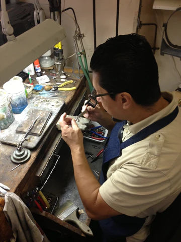 Goldsmith working on a metal piece