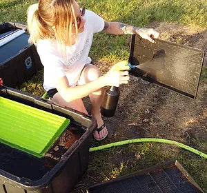 Mandi showing how to Spray Sanitize Microgreens Trays