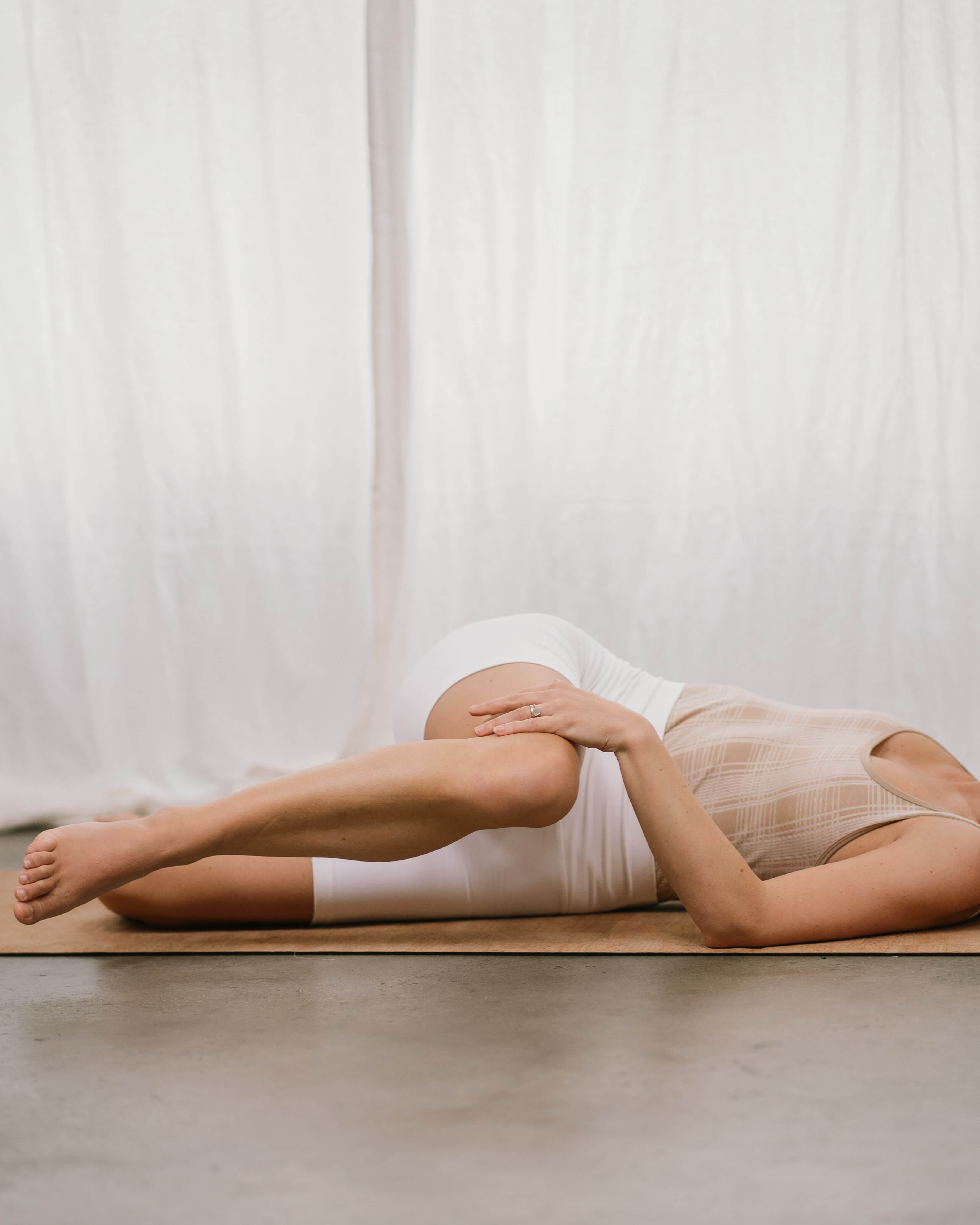 woman doing a supine spinal twist