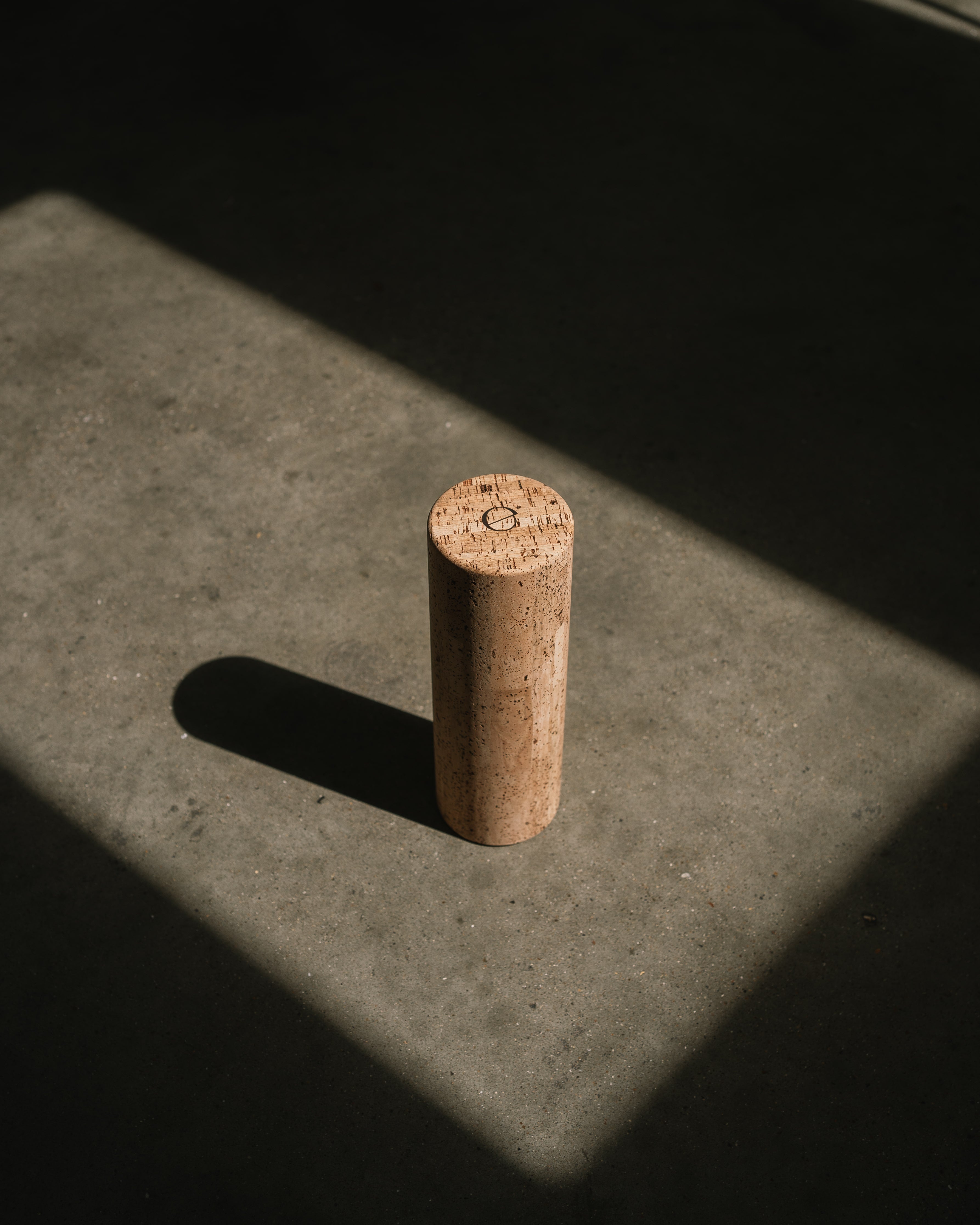 one noveme cork roller placed on a concrete floor