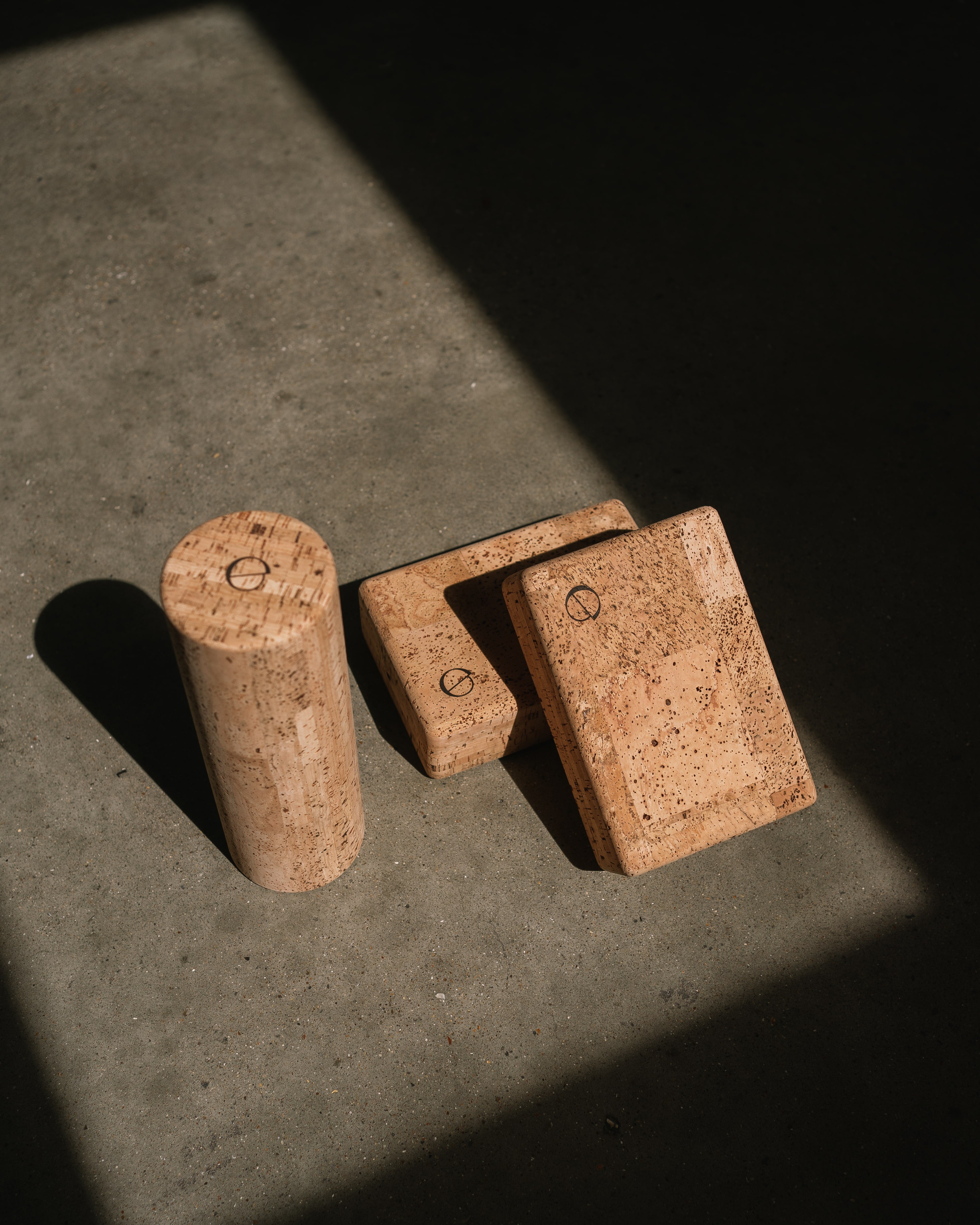 noveme cork yoga accessories placed on a concrete floor