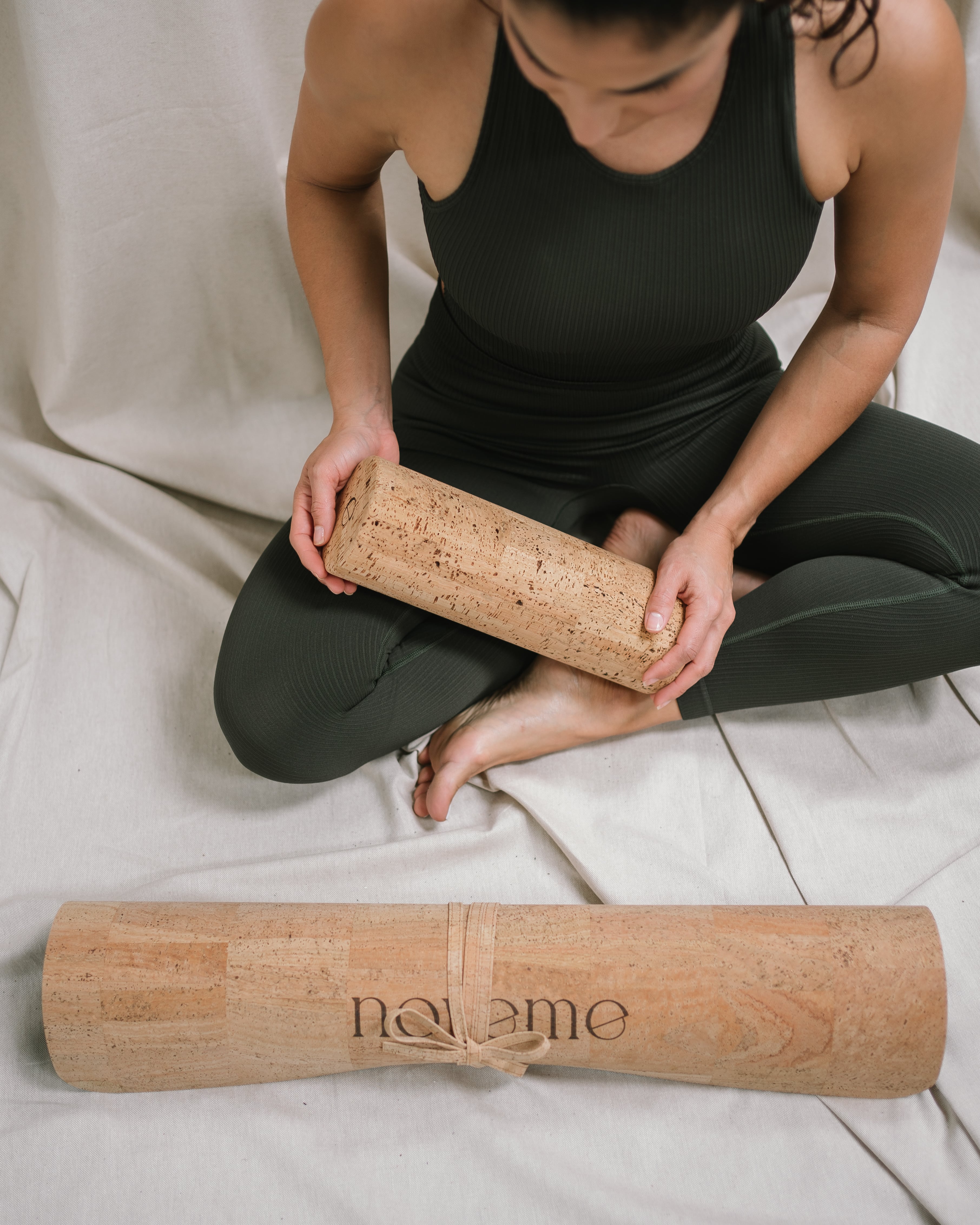 model holding a Noveme massage roller