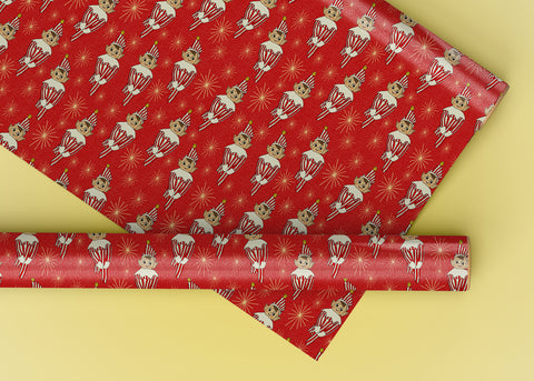 A wrapping paper roll featuring a red background with a vintage elf wearing a red and white striped outfit.