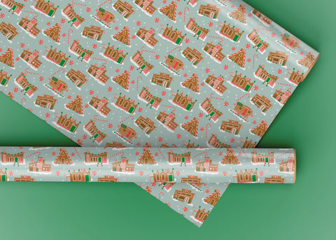 Wrapping paper roll featuring a pale blue background with Mid Century Modern style Gingerbread Houses in with a sweet nostalgic feel