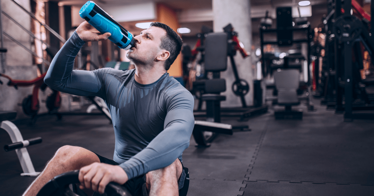 A man drinking from a water bottle | Ultimate Nutrition