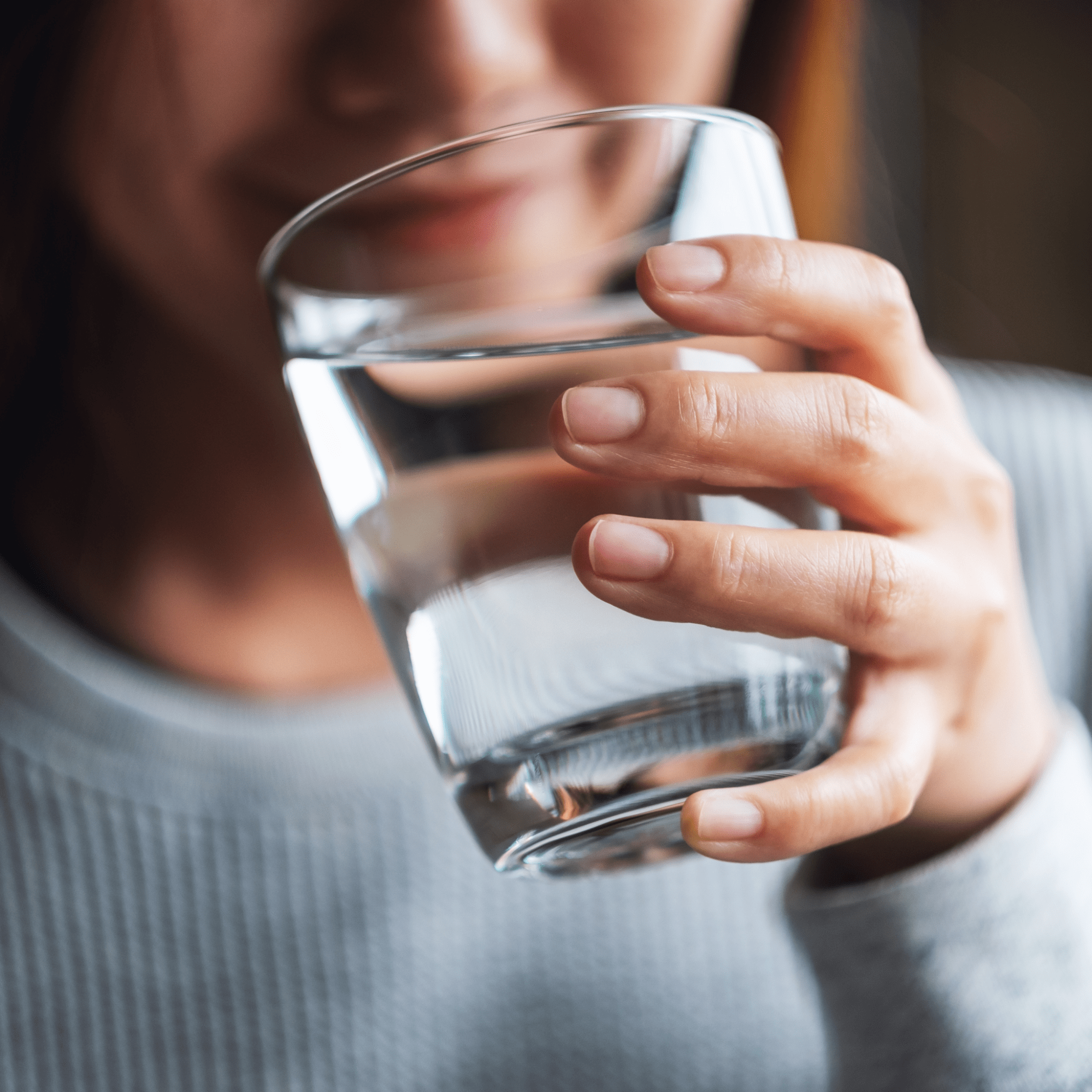 A woman drinking water | Ultimate Nutrition