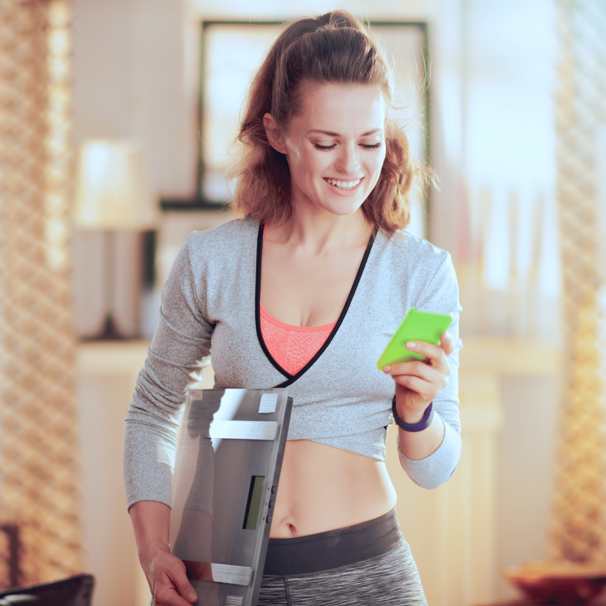 A Woman holding a scale | Ultimate Nutrition