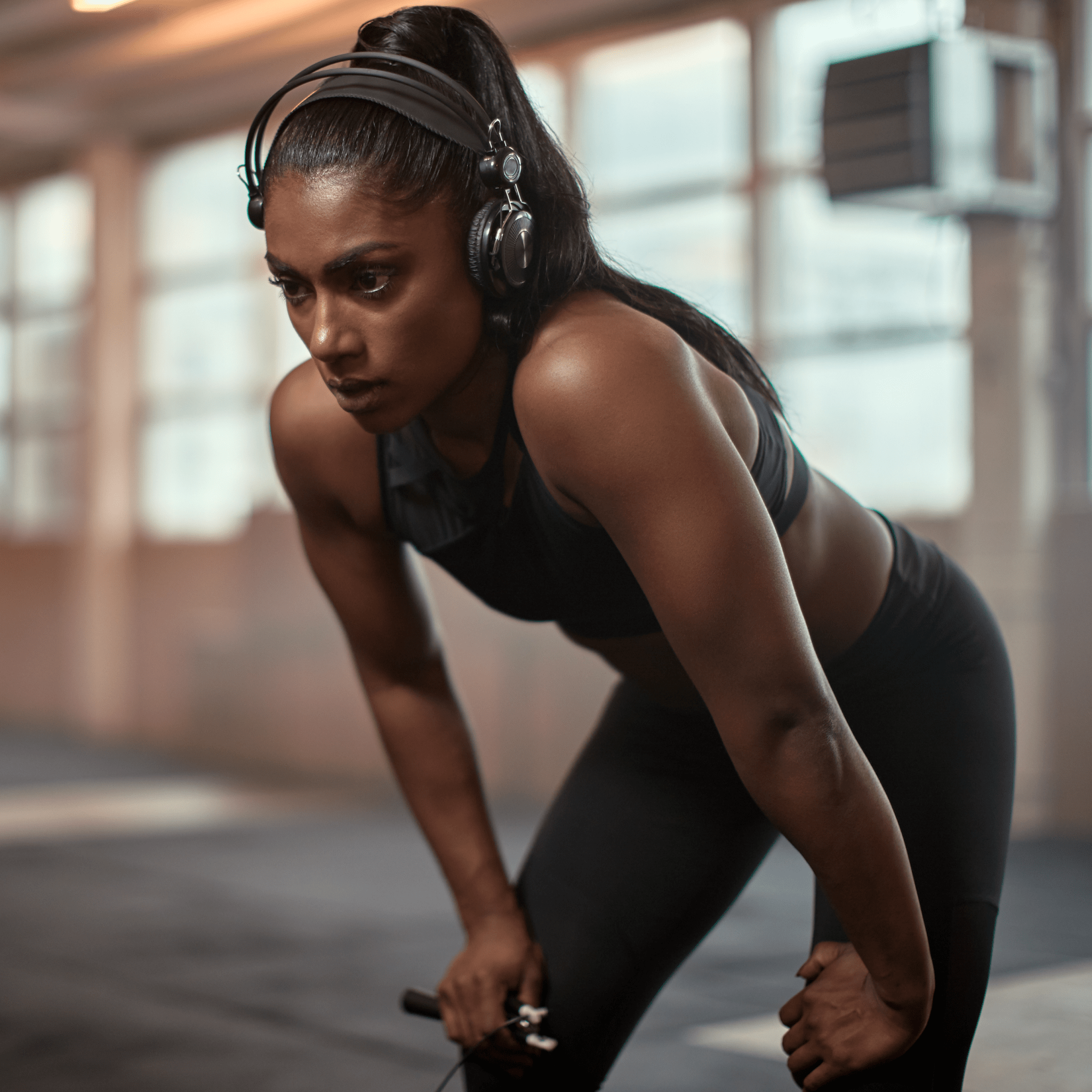 Woman catching breath while exercising | Ultimate Nutrition