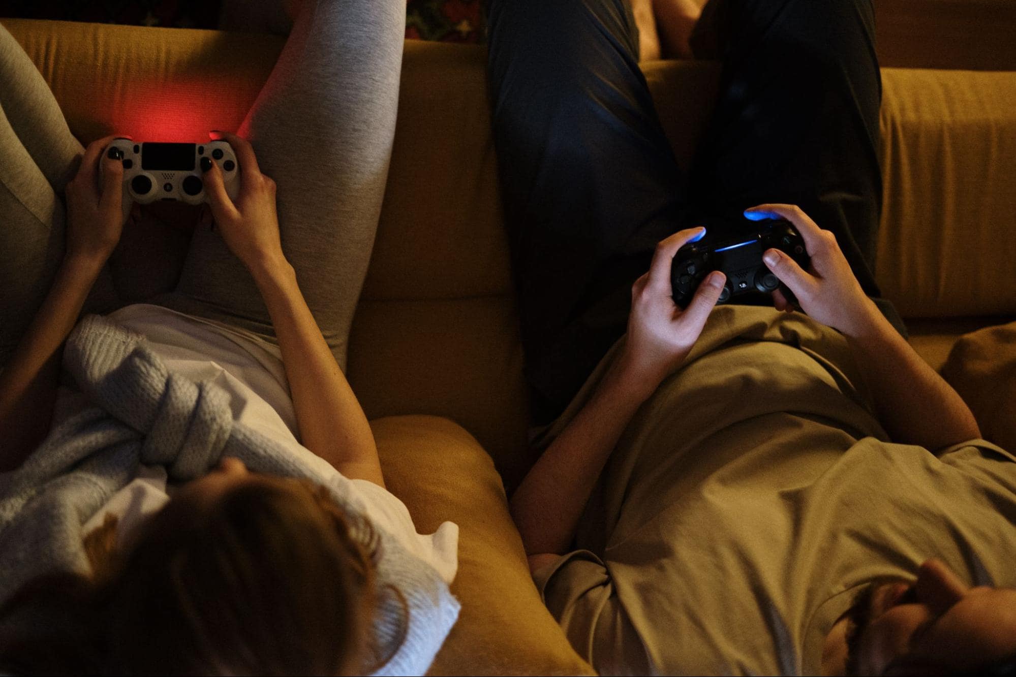 Two people playing with video game controllers
