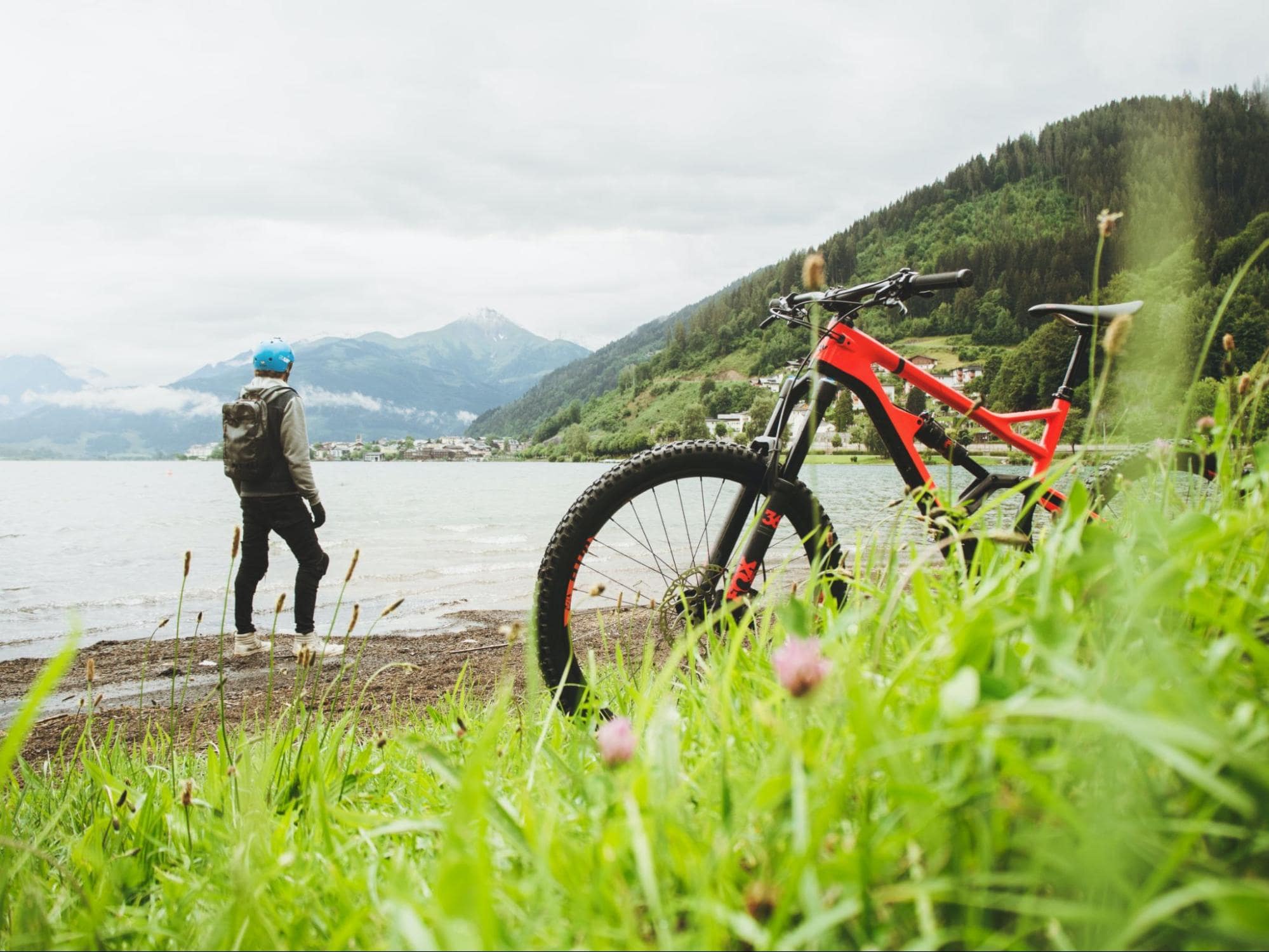 person standing outdoors beside a bike