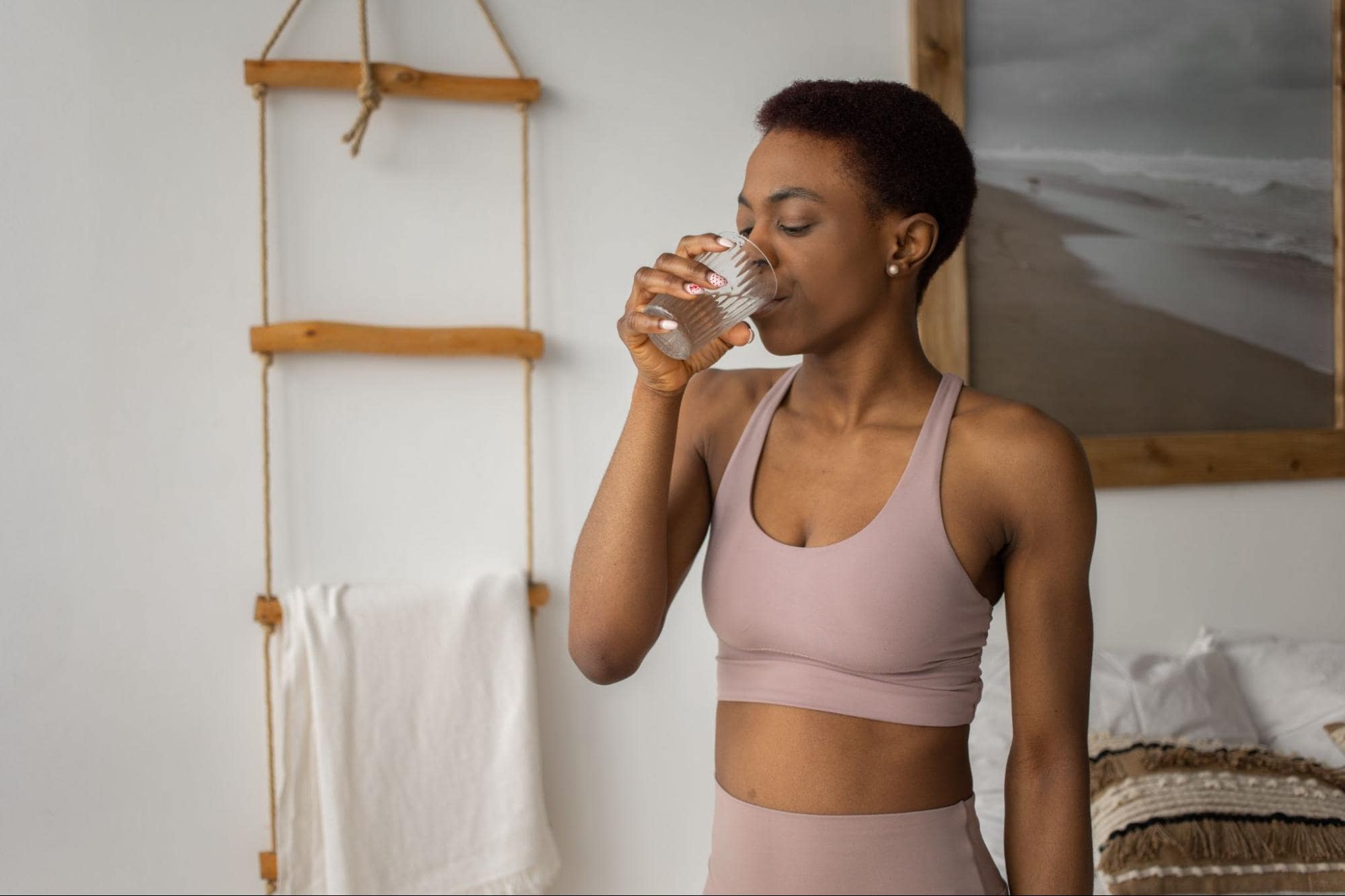 person drinking water wearing athletic clothing