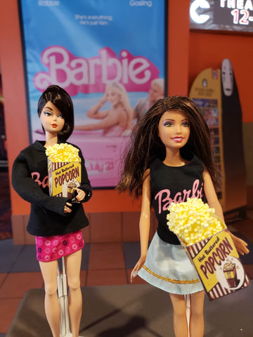 Barbie's in front of the sign