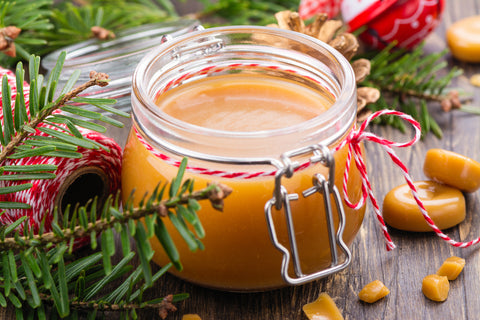 rich caramel sauce in mason jar with bow as a edible gift