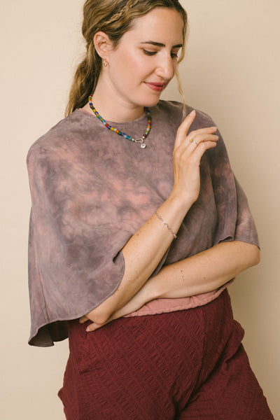 Molly Miller of Zest Dressed wearing her sustainable Zoom Cape; she styles it with RIVA New York jewelry