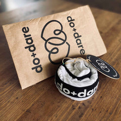 An undie puck, ready to be poked open, in front of its all paper padded mailer.