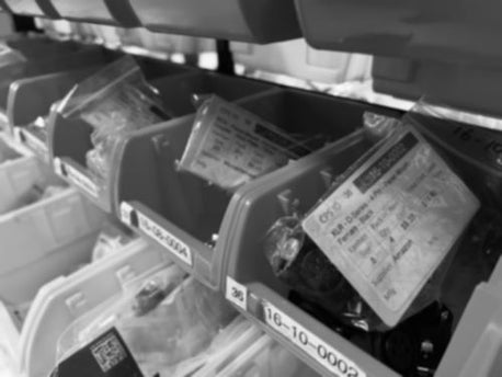 Black and White Image of electrical components in bins with kanban cards visible
