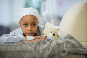 little cancer patient with teddy bear