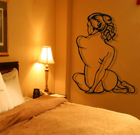 Elegant silhouette metal wall art beside cozy bed