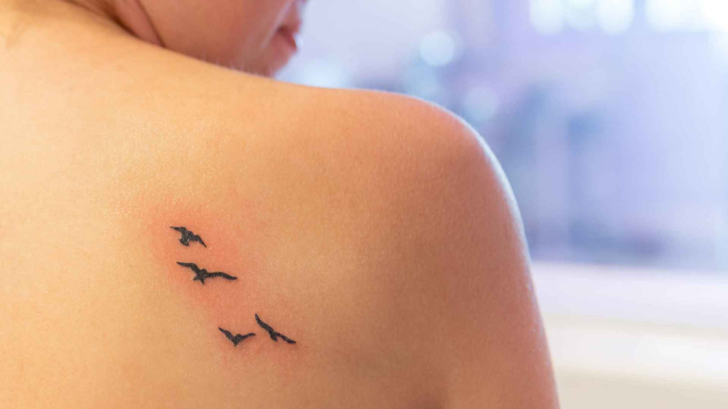 A woman with tattoo on her shoulder