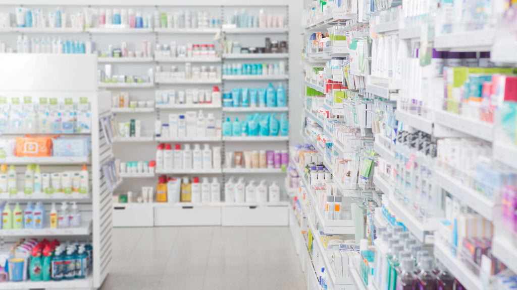 Aisle in a pharmacy with shelves stocked with various health and beauty products.