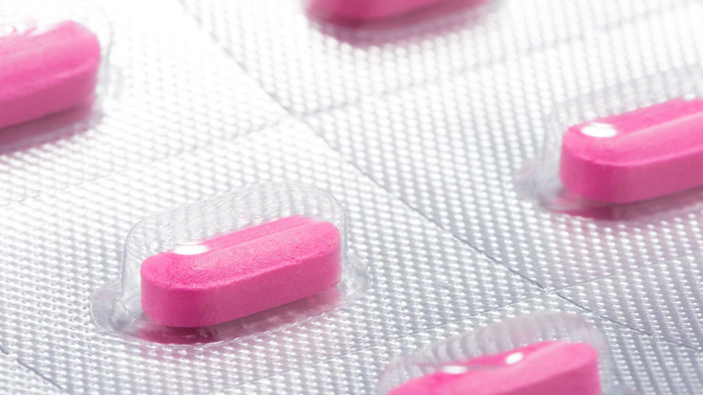 Blister pack of antihistamine pills on white background.