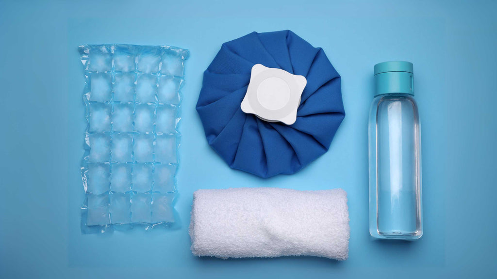 Cold compress and ice arranged on a blue background.