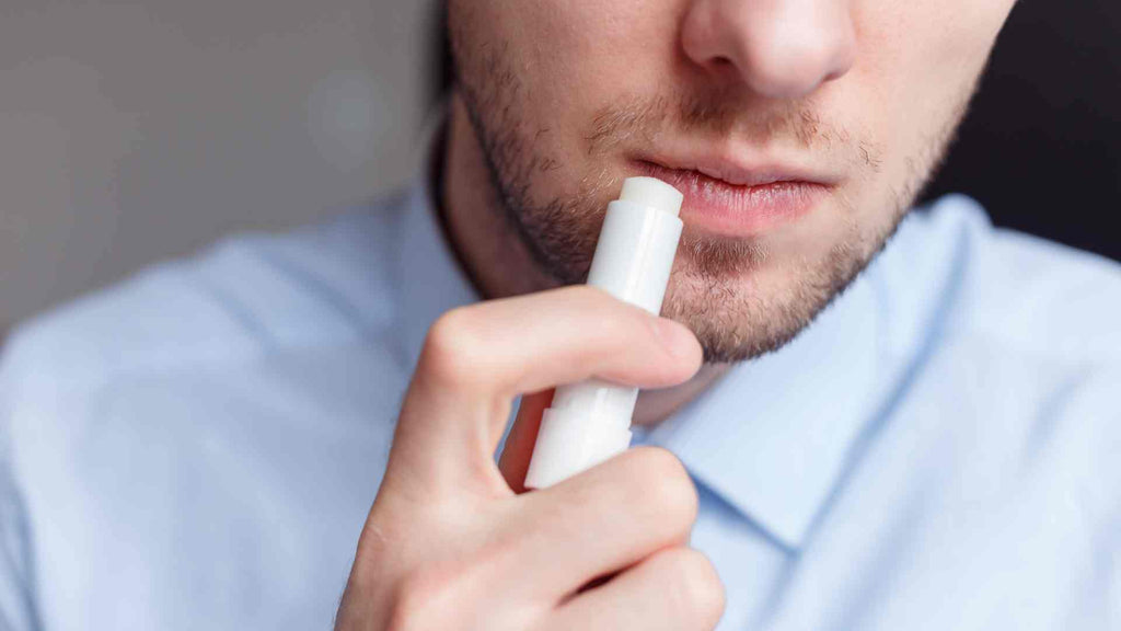 Man putting on lip balm