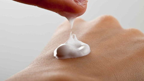 Moisturizer being applied to hand