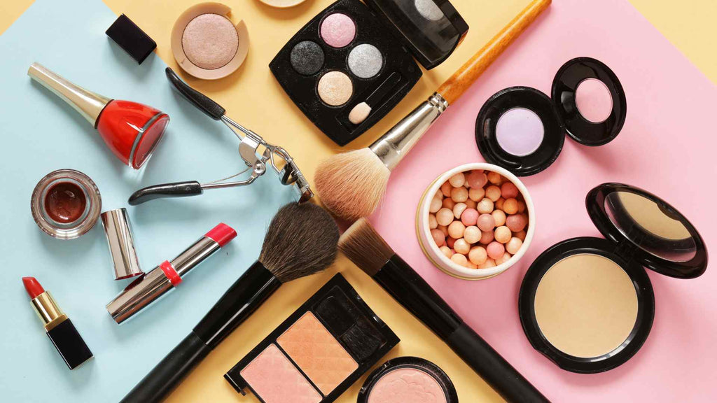 A variety of cosmetics are arranged on a colorful background.