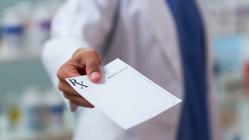 A doctor handing out a prescription