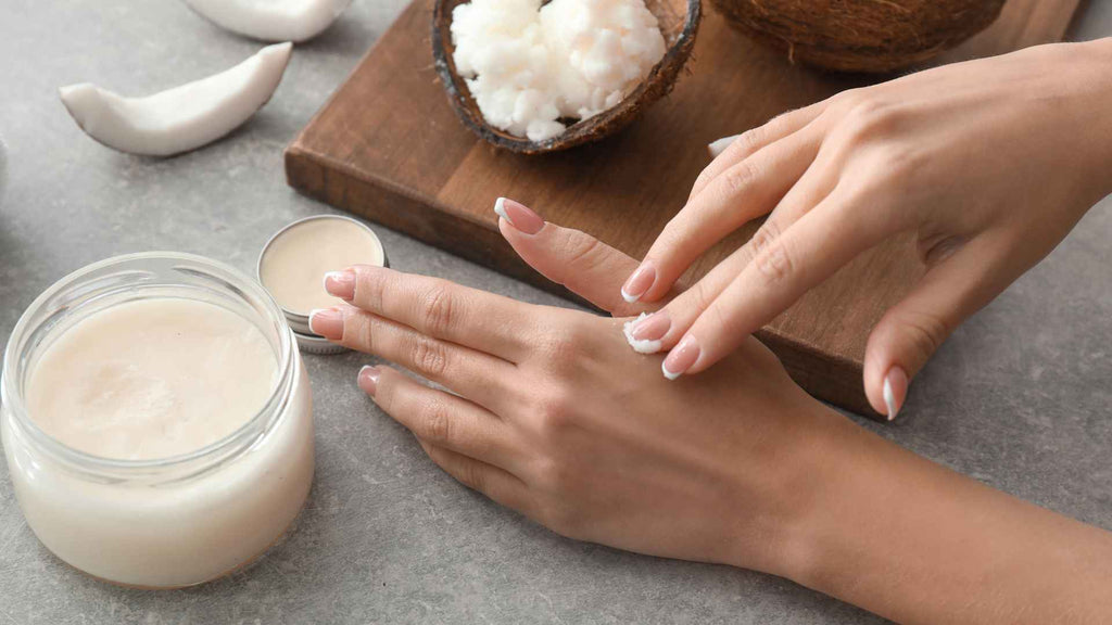 Individual moisturizing their skin with natural coconut oil.