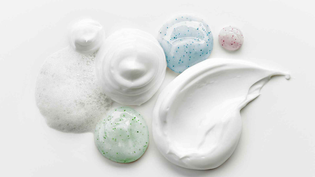 Various types of cleansing and beauty product textures on a white background.