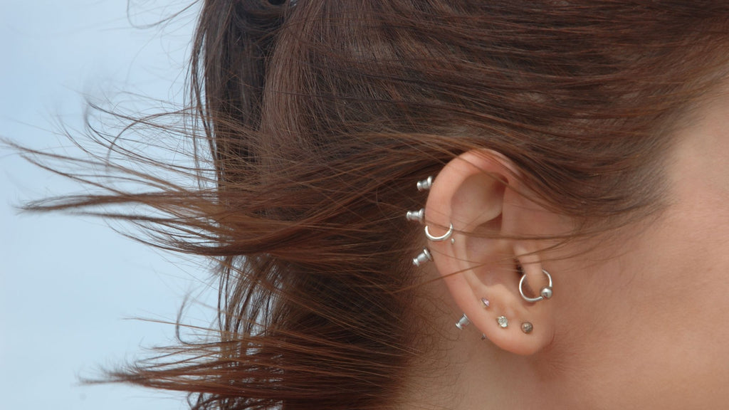 A woman with ear piercings on her ear.