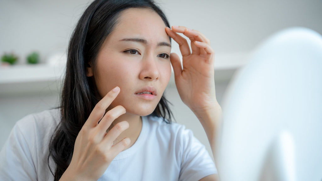 Woman checking out her skin.