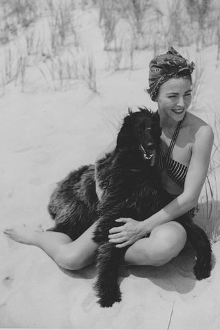 1930s photo of Mardee Hoff with black afghan dog at the beach in Hampton, NY